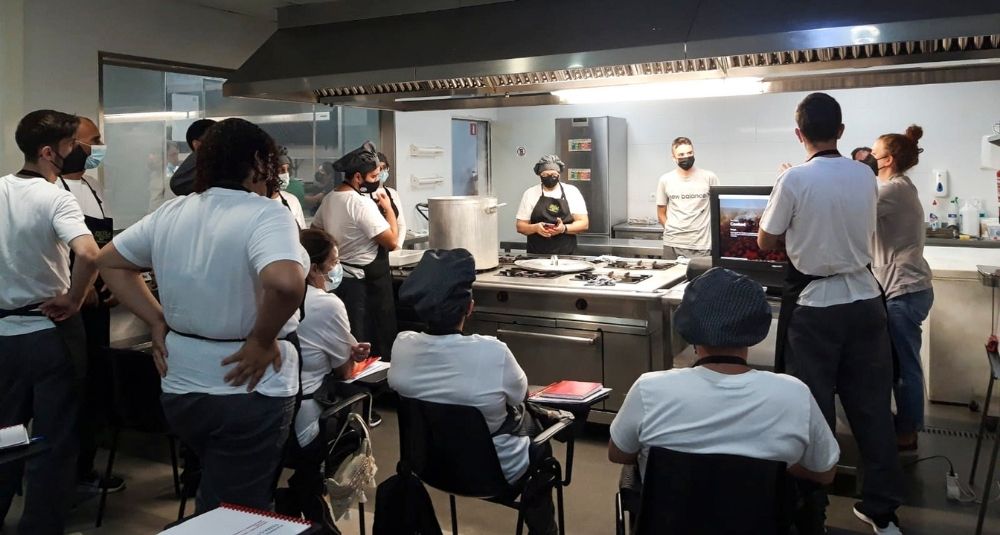 persones participants del curs d'auxiliar de cuina a la cuina de l’escola d’Hosteleria